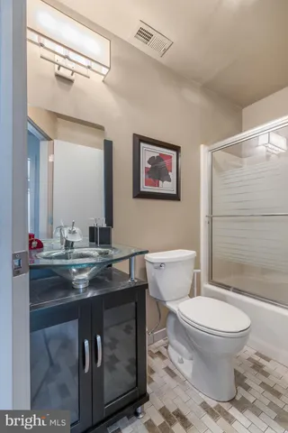 a view of a hallway with wooden floor and dining room