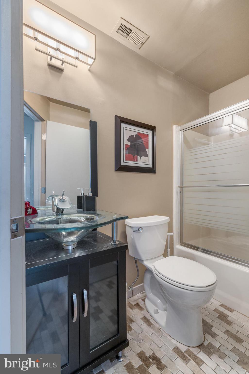 5213 Le Parc Drive, Unit 4 Wilmington, DE 19809 - Photo 26 of 37 a bathroom with a toilet sink and mirror