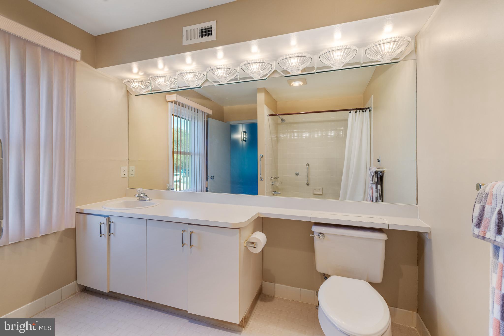 5213 Le Parc Drive, Unit 4 Wilmington, DE 19809 - Photo 34 of 37 a bathroom with a toilet a sink and mirror