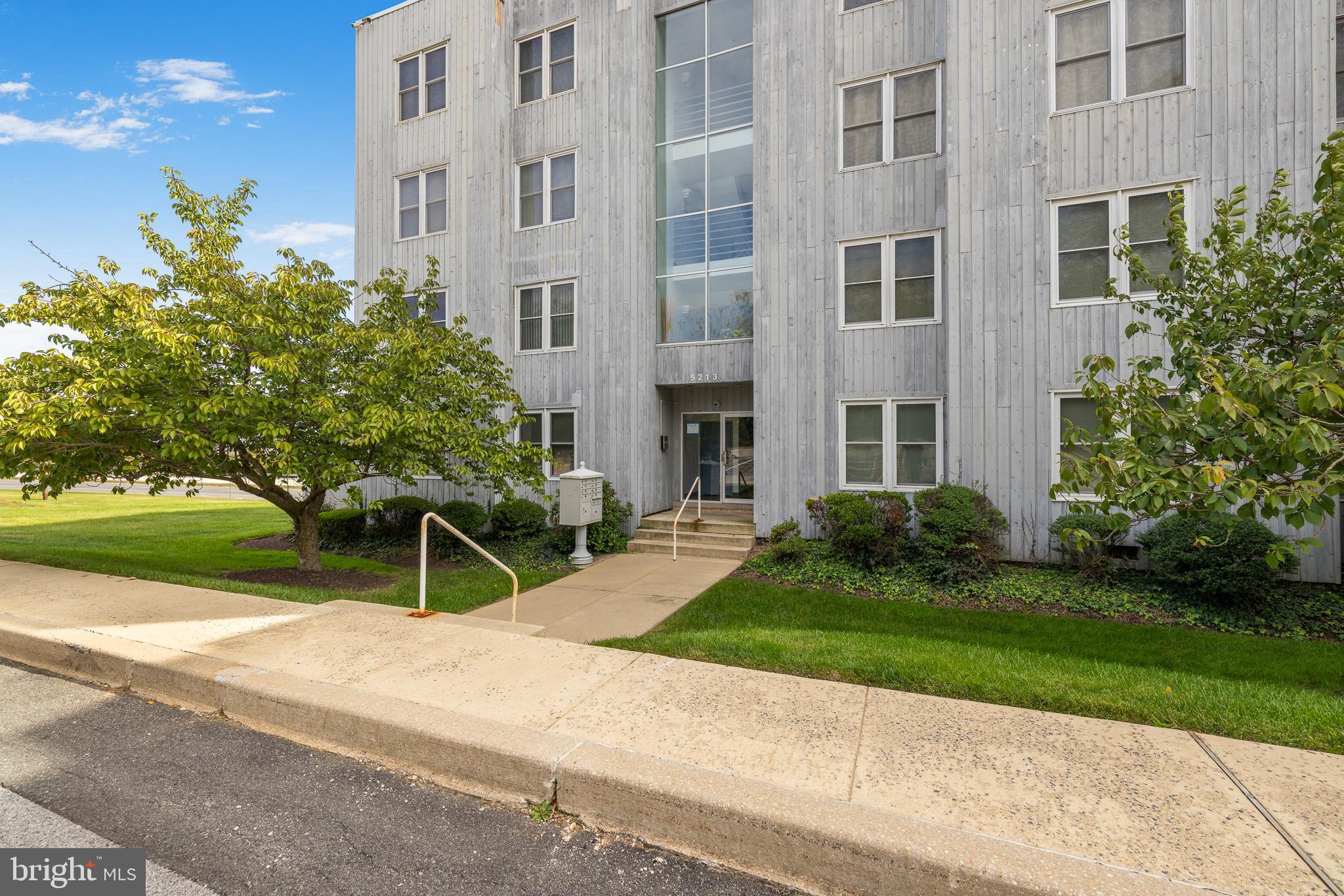 5213 Le Parc Drive, Unit 4 Wilmington, DE 19809 - Photo 7 of 37 a view of a building with a yard and sitting area