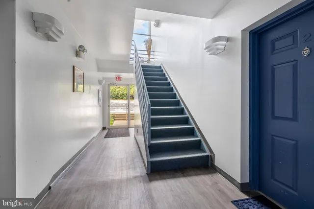 an empty room with entrance and windows