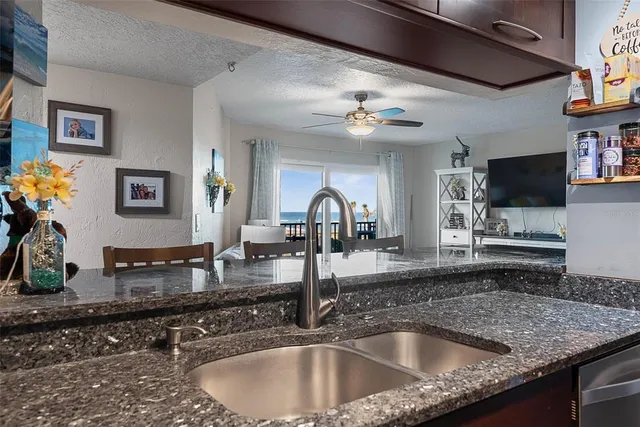 a kitchen with sink a faucet and a stove