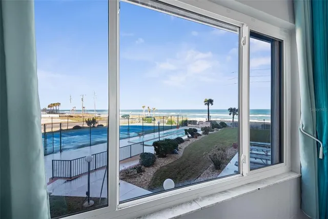 a bedroom with a bed and a flat screen tv in white dresser