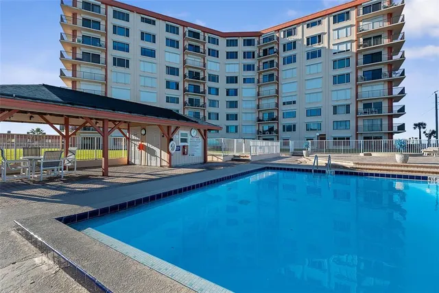 a view of a swimming pool with a lounge chair