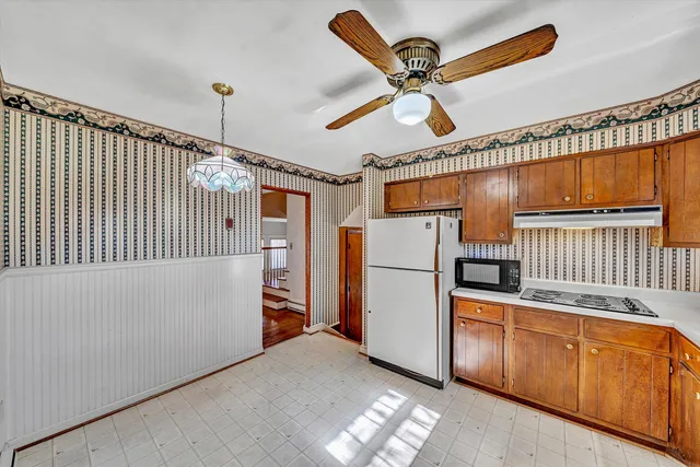 a kitchen with stainless steel appliances granite countertop a refrigerator a stove and a sink