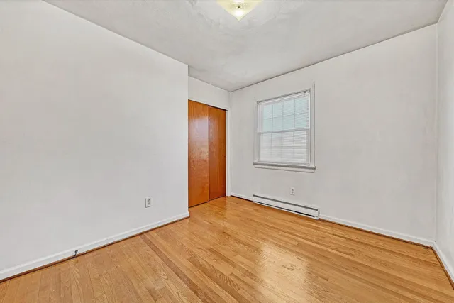 a view of a room with window and ceiling fan