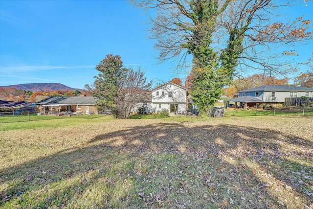 a view of a house with a yard and sitting area