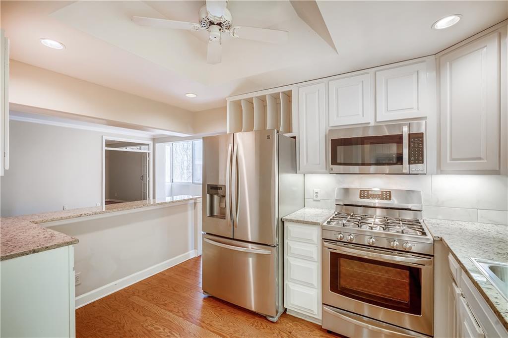 2632 Peachtree Road Northwest, Unit A301 Atlanta, GA 30305 - Photo 1 of 1 a kitchen with stainless steel appliances granite countertop a stove a refrigerator and a microwave