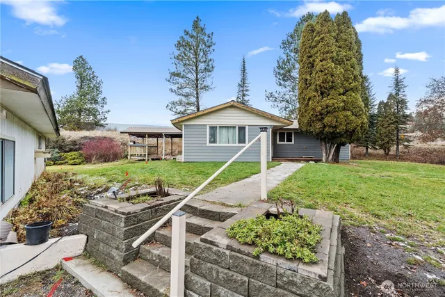 a front view of a house with a garden