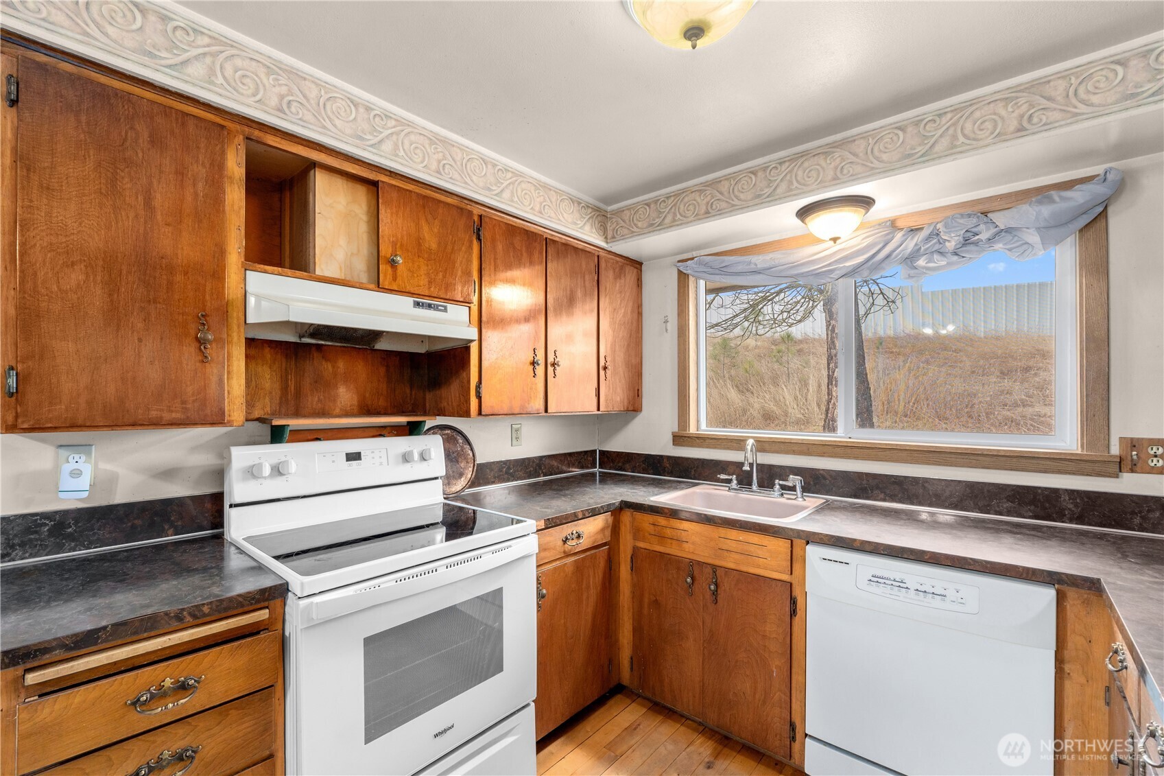 526 Greenwood Loop Road Kettle Falls, WA 99141 - Photo 16 of 35 a kitchen with a stove a sink and a microwave