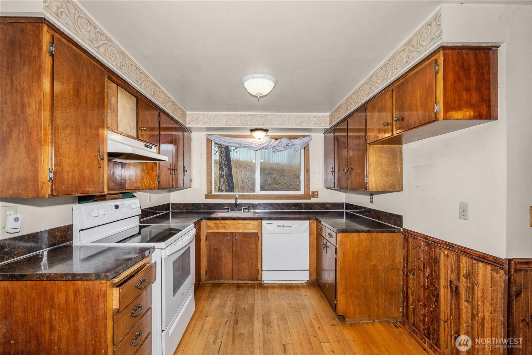 526 Greenwood Loop Road Kettle Falls, WA 99141 - Photo 17 of 35 a kitchen with stainless steel appliances granite countertop a stove a sink and a microwave