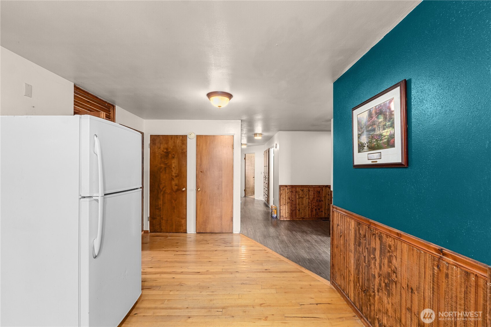 526 Greenwood Loop Road Kettle Falls, WA 99141 - Photo 19 of 35 a view of a hallway with wooden floor and staircase