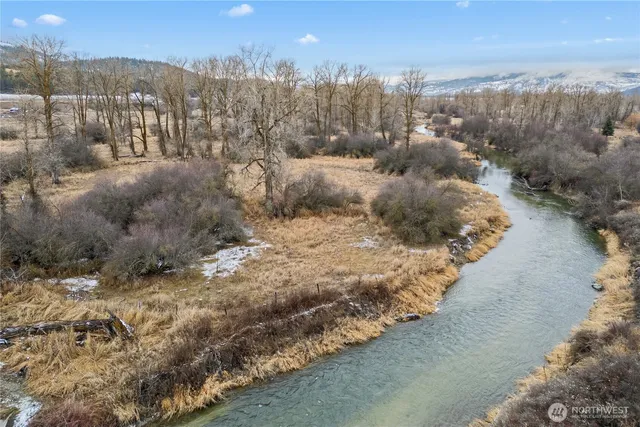 a view of a hallway with entryway and stairs