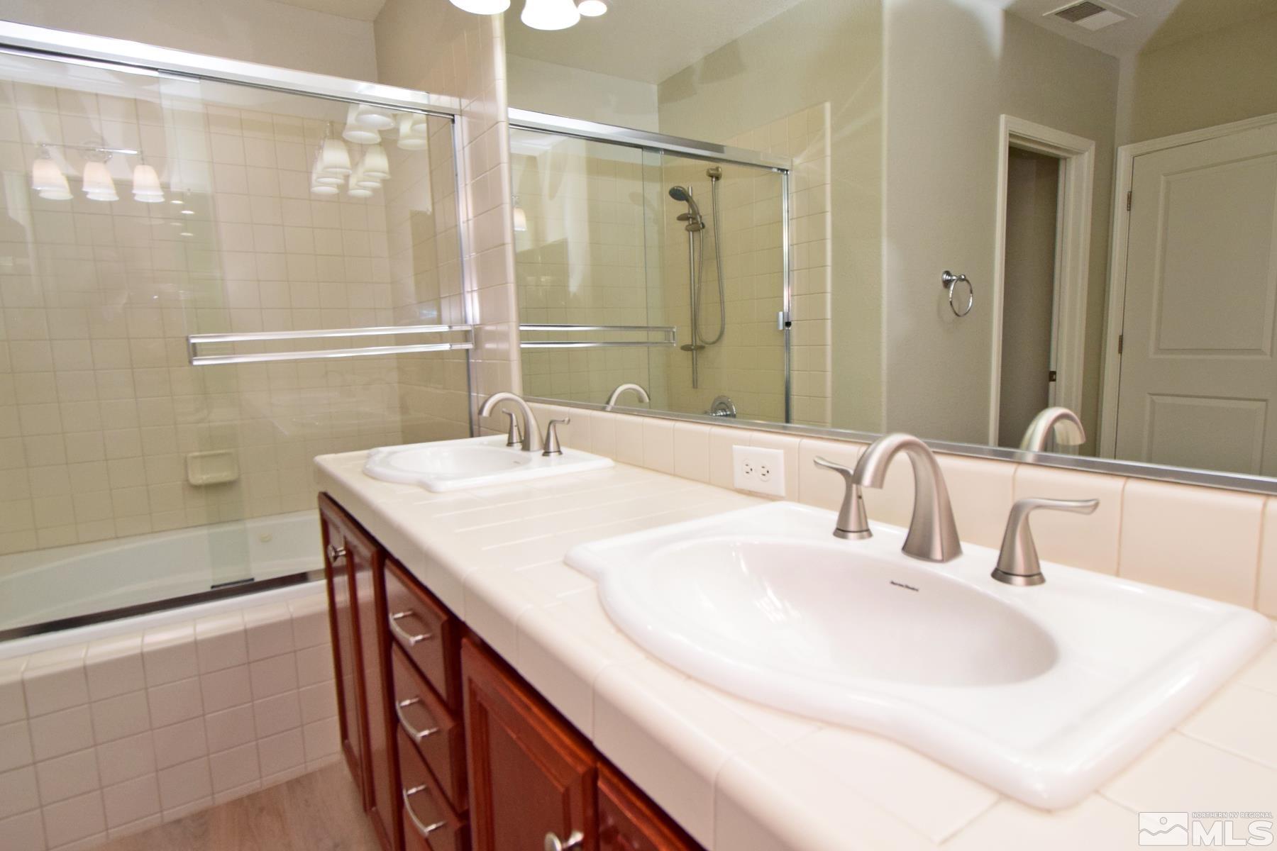 1689 Clover Hill Trail Reno, NV 89523 - Photo 13 of 32 a bathroom with a sink and a mirror