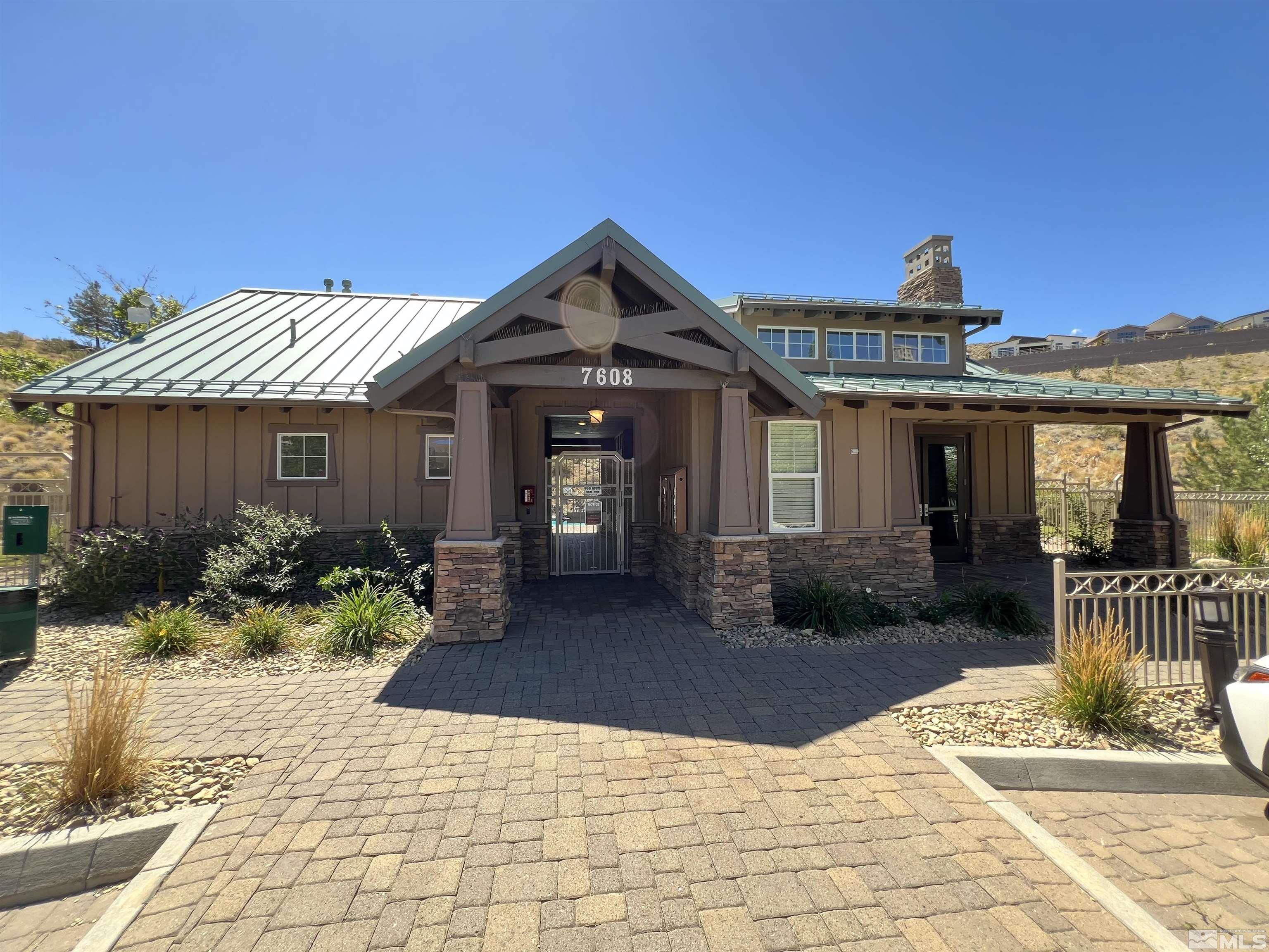 1689 Clover Hill Trail Reno, NV 89523 - Photo 14 of 32 a front view of a house with a yard and potted plants