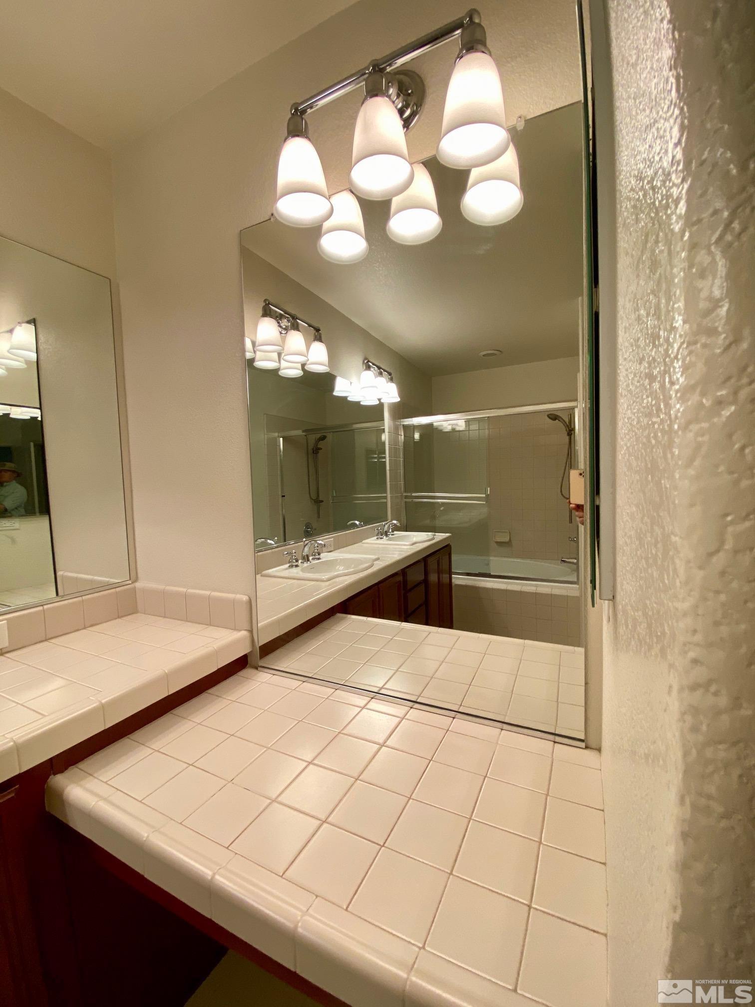 1689 Clover Hill Trail Reno, NV 89523 - Photo 28 of 32 a bathroom with a sink and a mirror