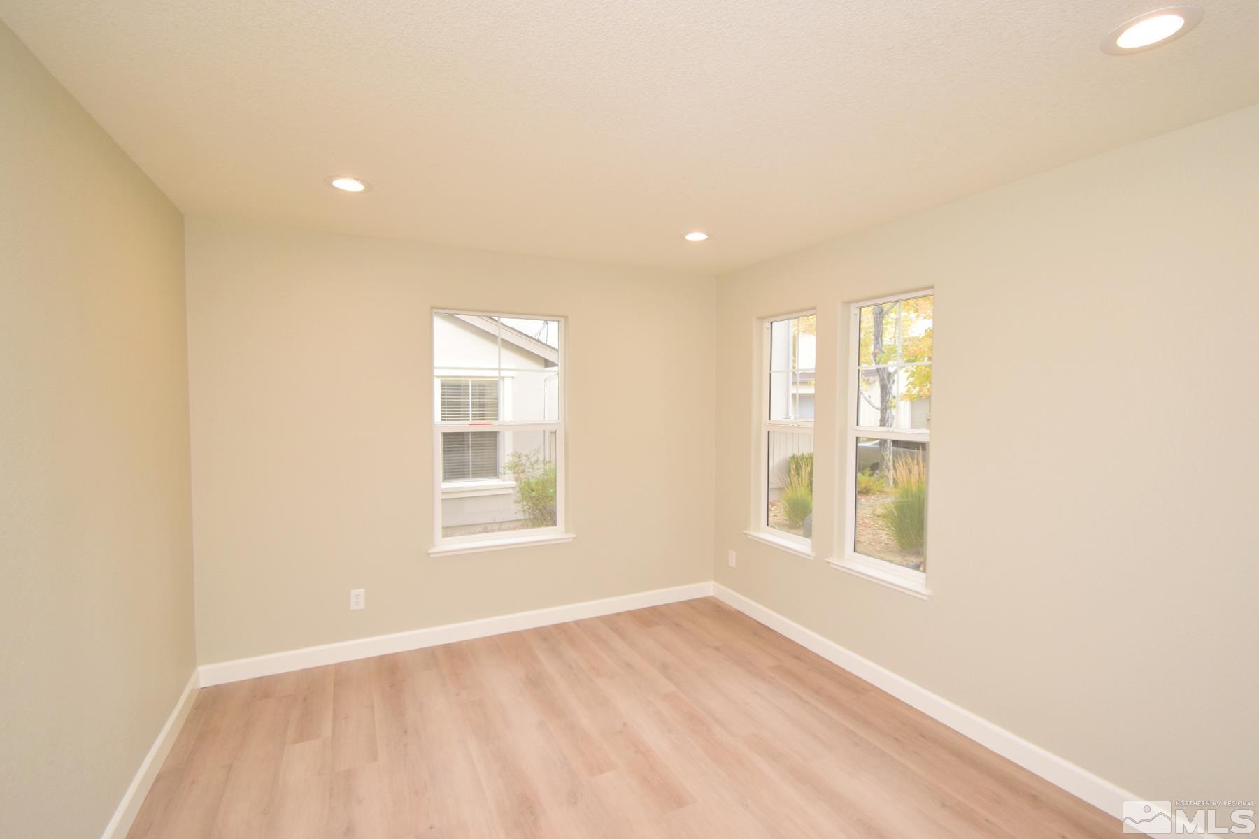 1689 Clover Hill Trail Reno, NV 89523 - Photo 31 of 32 an empty room with wooden floor and windows