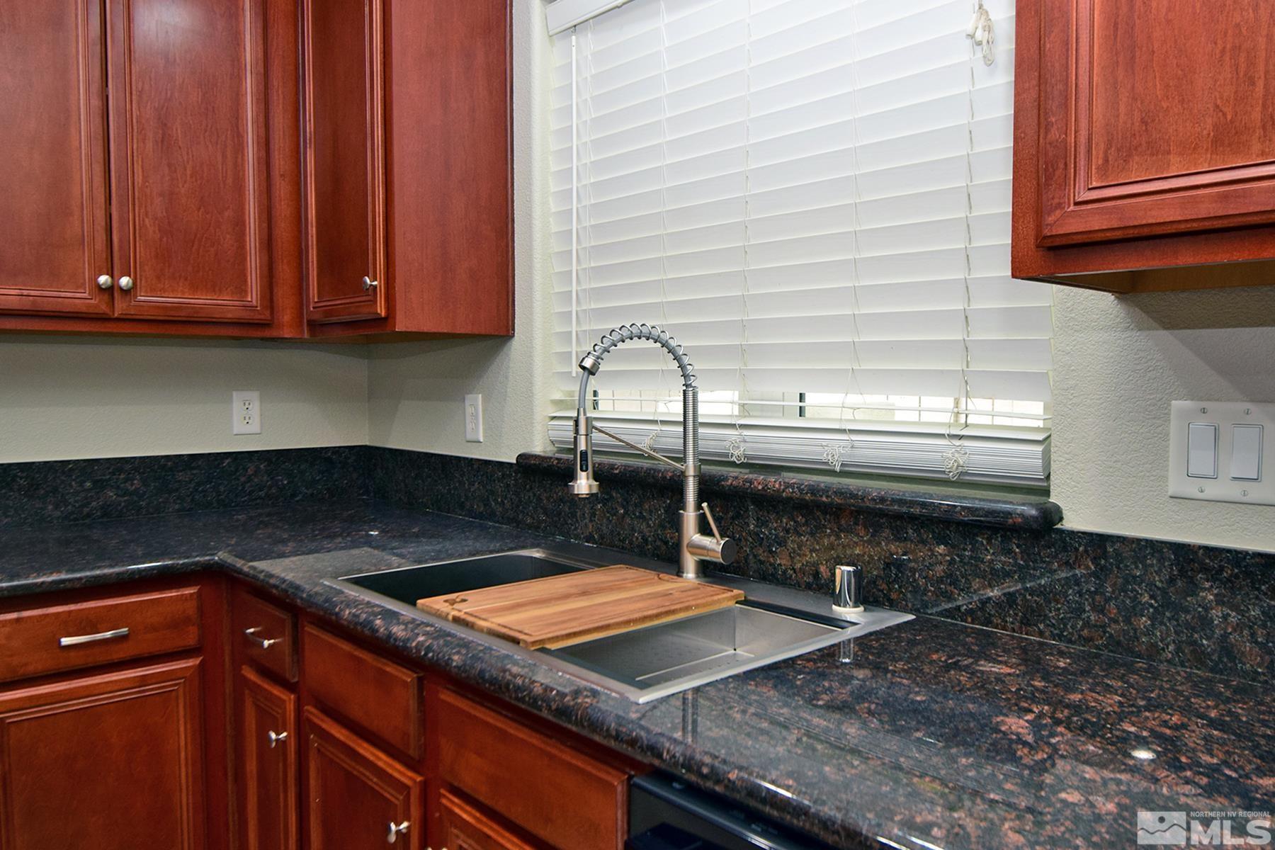1689 Clover Hill Trail Reno, NV 89523 - Photo 9 of 32 a kitchen with granite countertop a sink and a stove