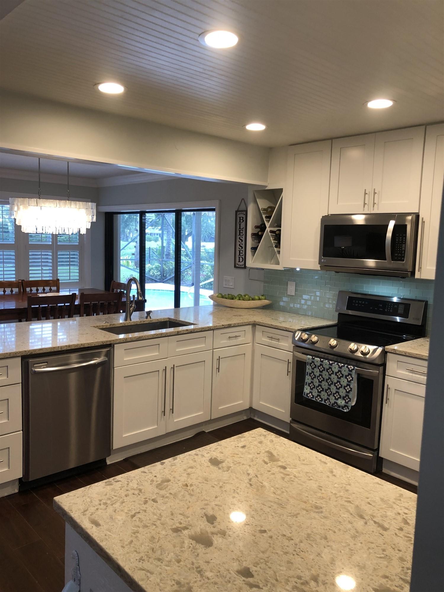 67 Fairview West Tequesta, FL 33469 - Photo 13 of 25 a kitchen with a sink cabinets and window