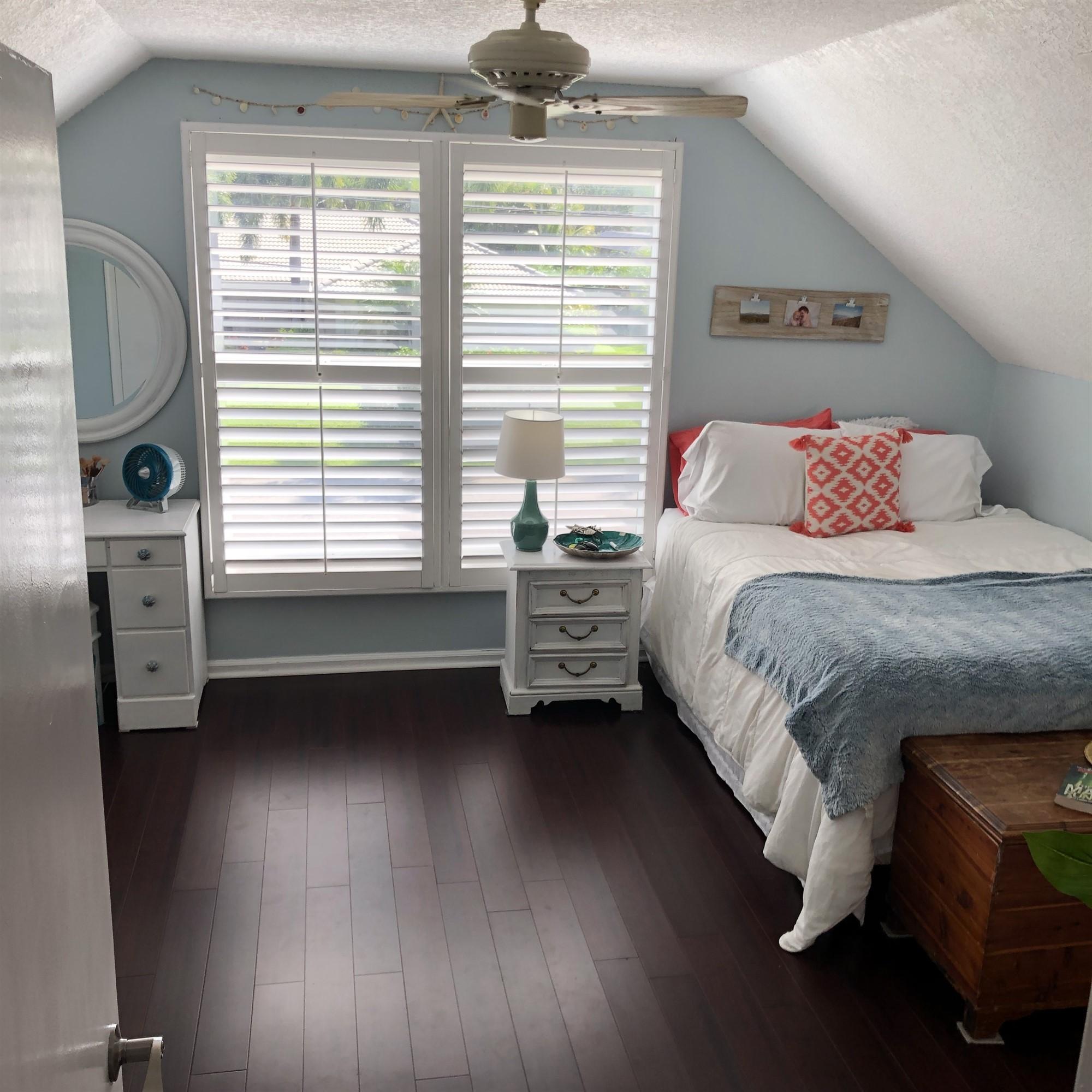 67 Fairview West Tequesta, FL 33469 - Photo 14 of 25 a bedroom with a bed a fireplace and a chandelier