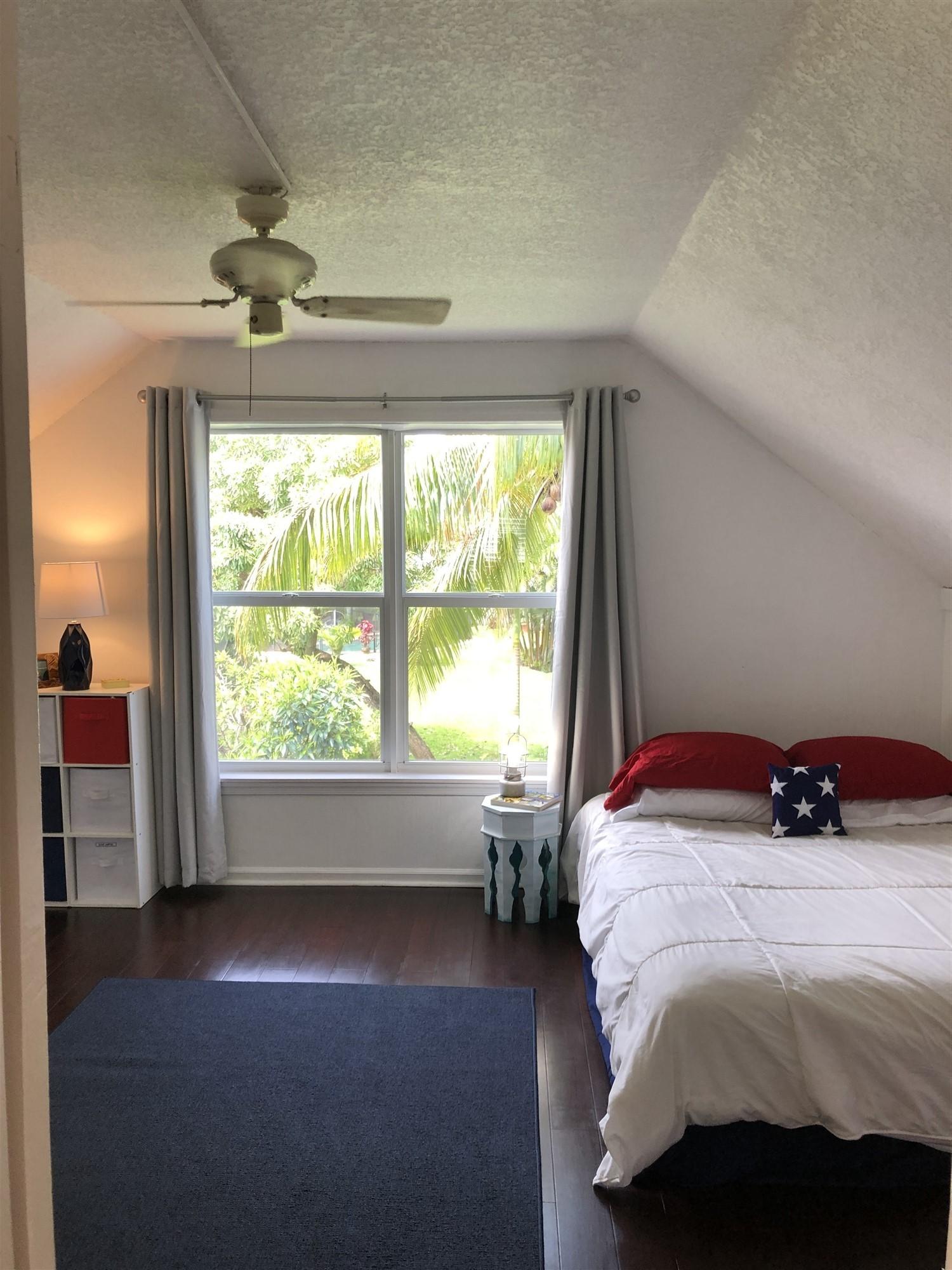 67 Fairview West Tequesta, FL 33469 - Photo 16 of 25 a bedroom with a bed and a window