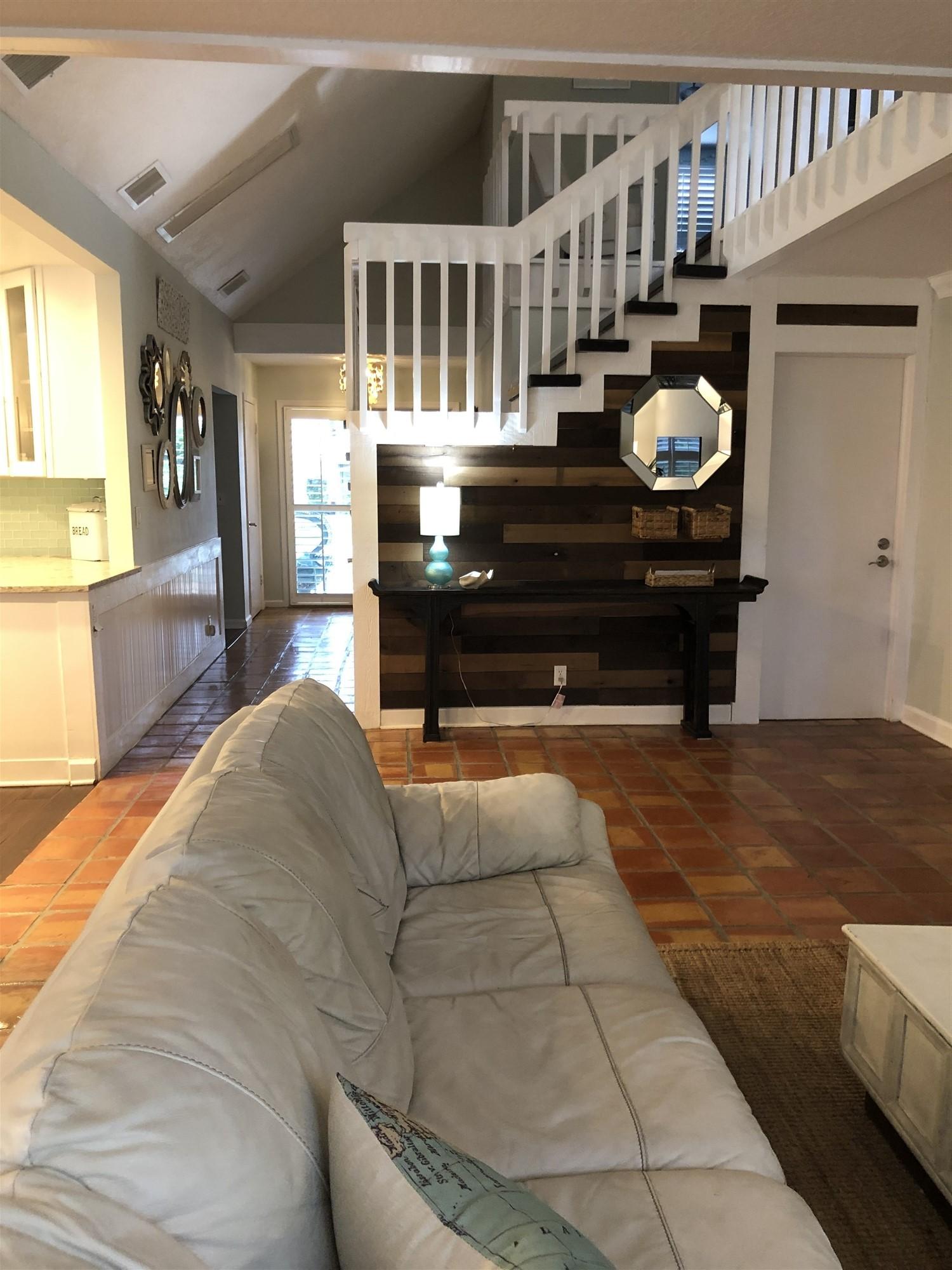 67 Fairview West Tequesta, FL 33469 - Photo 21 of 25 a living room with couches a fireplace and dining table with wooden floor