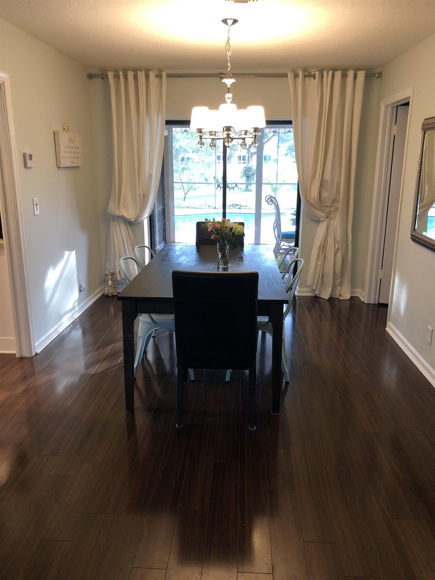 67 Fairview West Tequesta, FL 33469 - Photo 22 of 25 a view of a dining room with furniture window and wooden floor