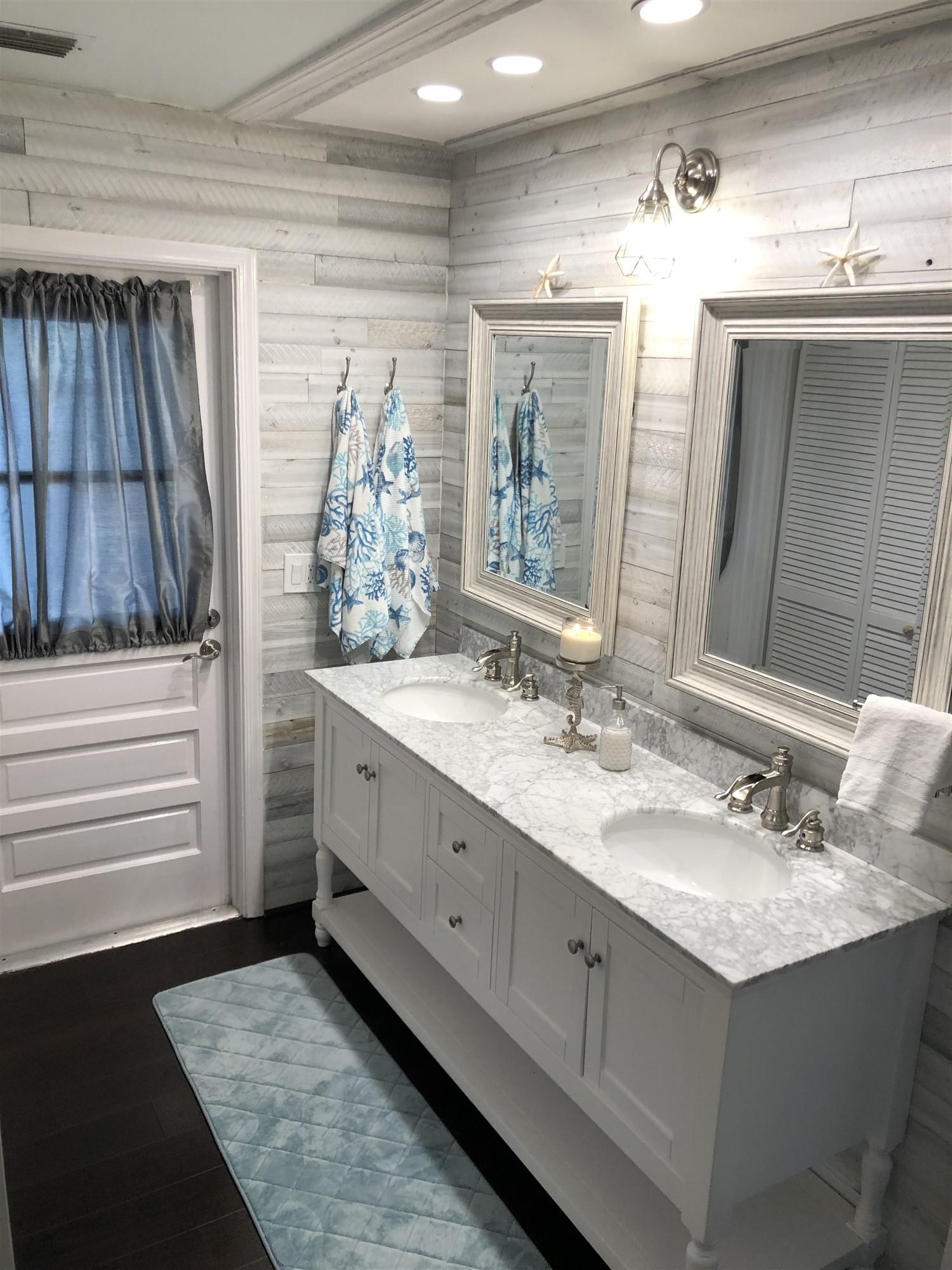 67 Fairview West Tequesta, FL 33469 - Photo 25 of 25 a bathroom with a double vanity sink and a mirror