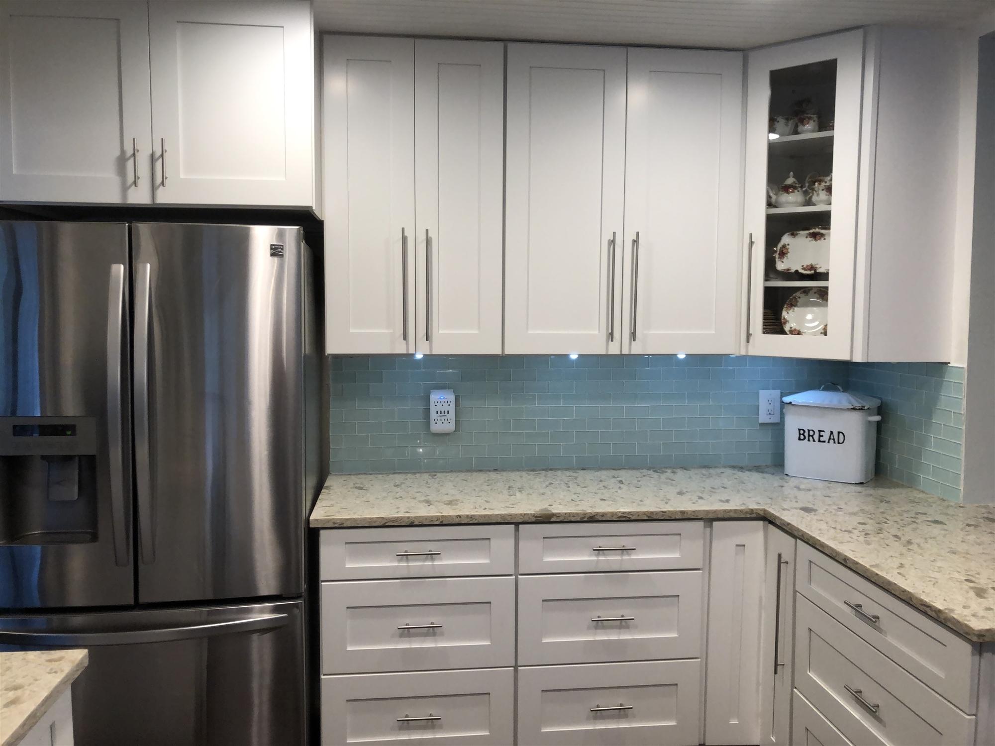 67 Fairview West Tequesta, FL 33469 - Photo 9 of 25 a kitchen with granite countertop a refrigerator and cabinets
