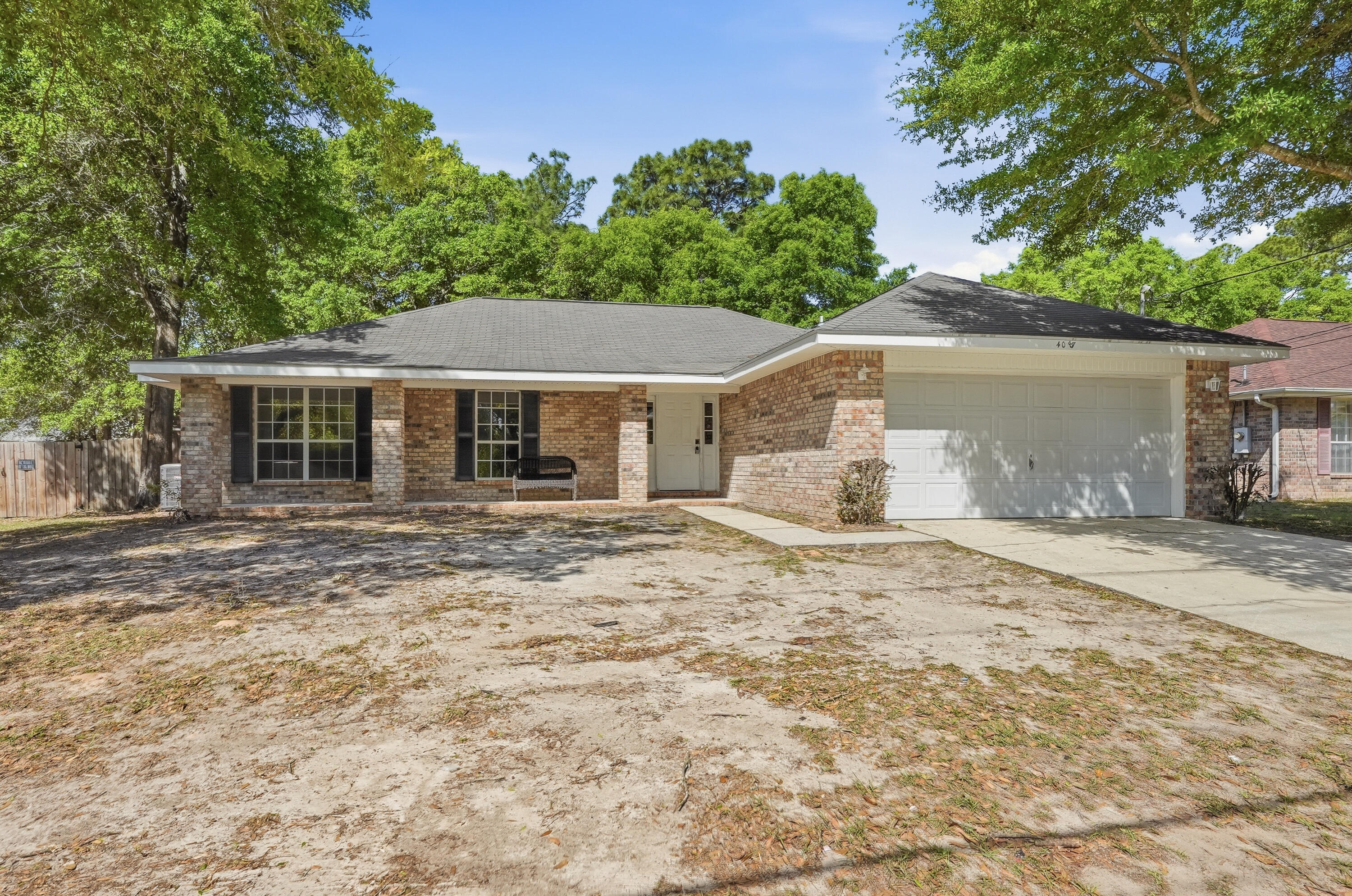 4087 Audiss Road Milton, FL 32583 - Photo 2 of 34 a house with trees in the background