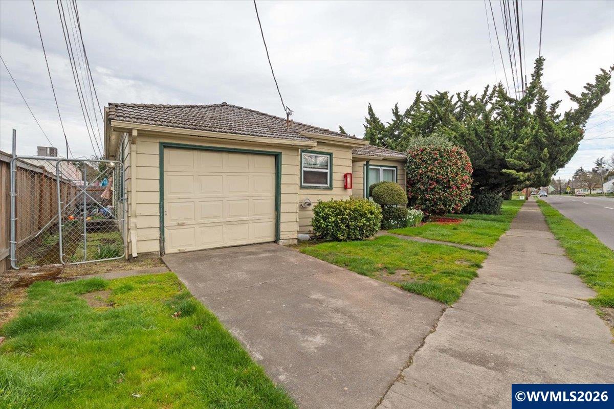 1735 Market Street Northeast Salem, OR 97301 - Photo 4 of 11 a front view of a house with a yard and garage