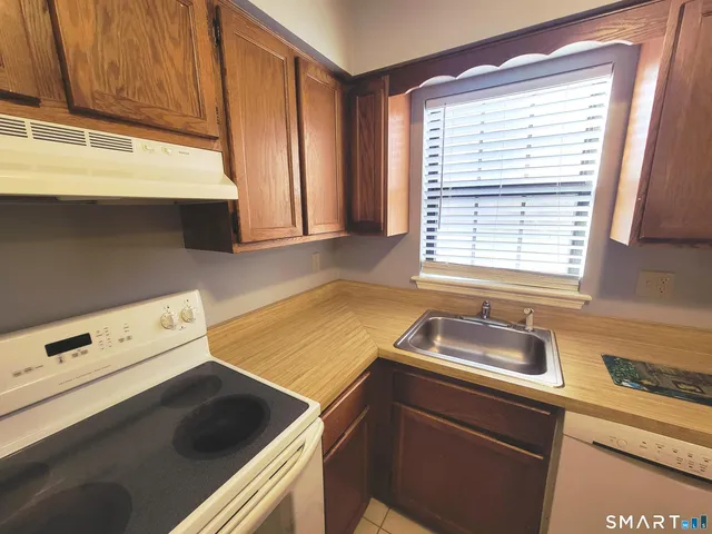 a kitchen with a sink cabinets and window