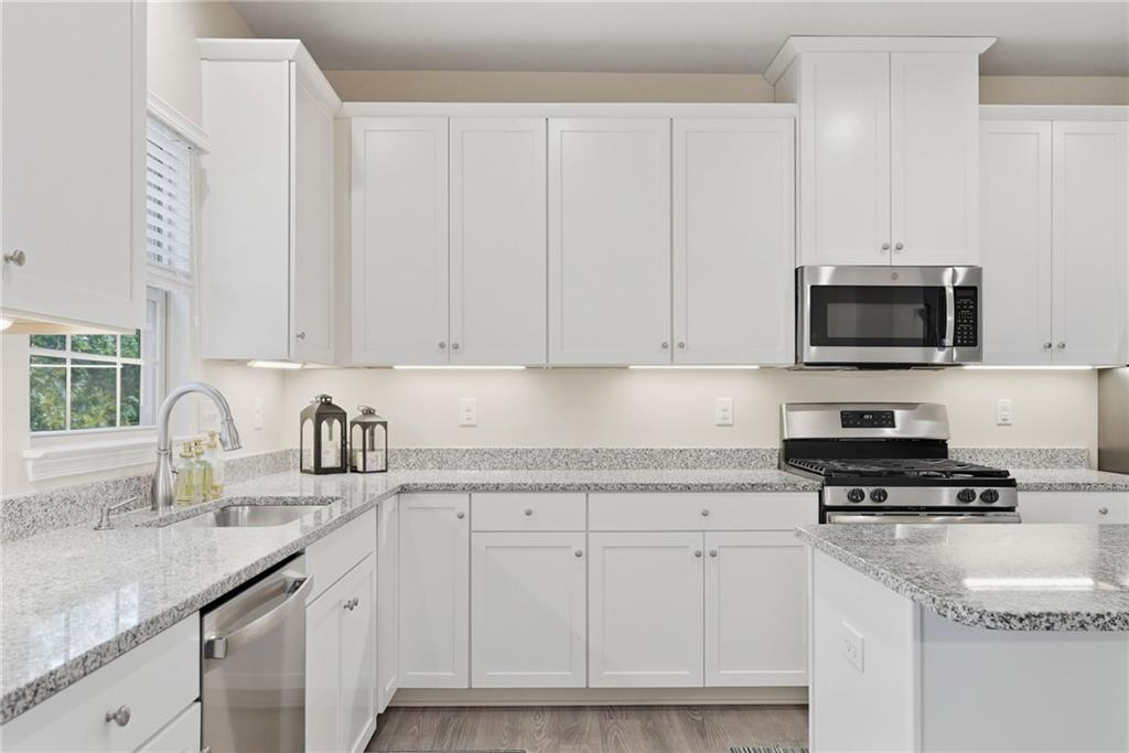 141 Arbor Trail Drive McKees Rocks, PA 15136 - Photo 13 of 44 a kitchen with granite countertop white cabinets and black appliances
