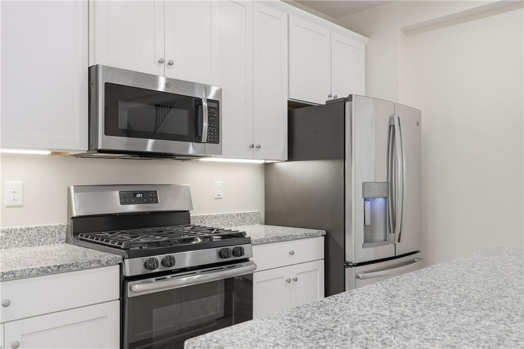141 Arbor Trail Drive McKees Rocks, PA 15136 - Photo 14 of 44 a kitchen with stainless steel appliances granite countertop a stove and a refrigerator
