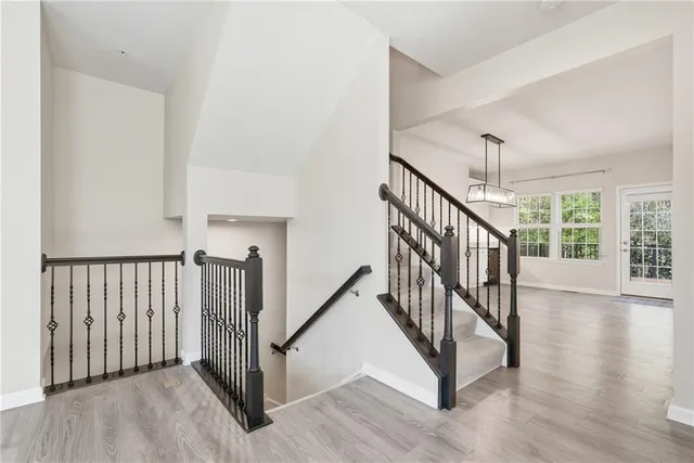 a view of staircase with railing and a window