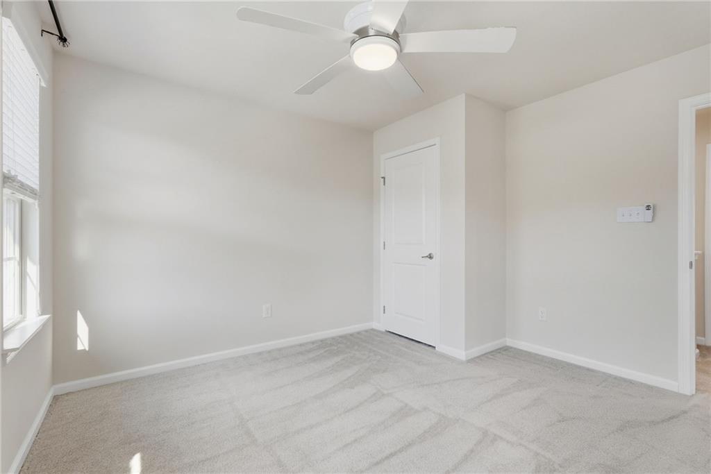 141 Arbor Trail Drive McKees Rocks, PA 15136 - Photo 17 of 44 an empty room with a window and a chandelier fan