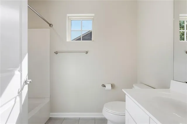 a white toilet sitting next to a white sink