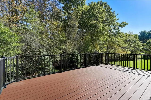 a view of a balcony with wooden floor and fence