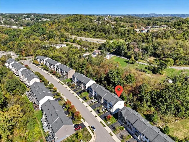 an aerial view of residential houses with outdoor space
