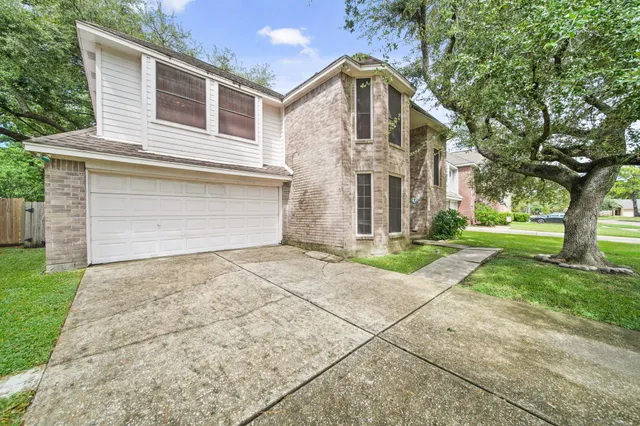 a front view of a house with a yard and a garage
