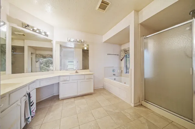 a bathroom with a granite countertop sink a toilet and bathtub