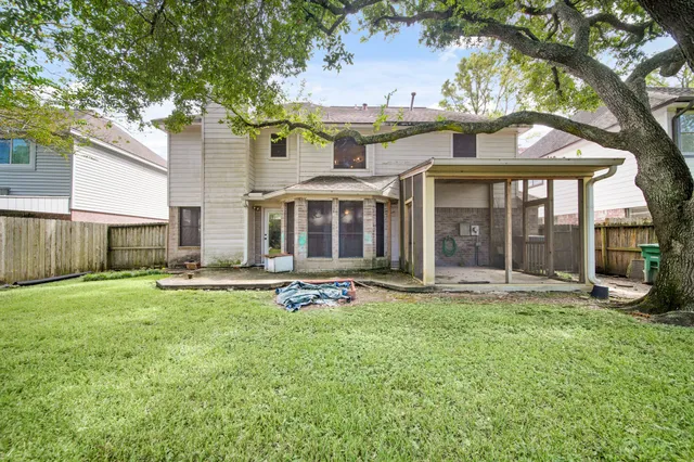 a view of a house with backyard porch and sitting area