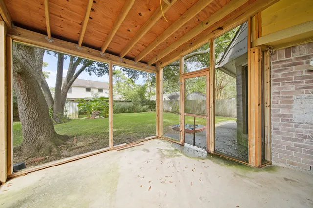 a view of a room with wooden floor and iron stairs