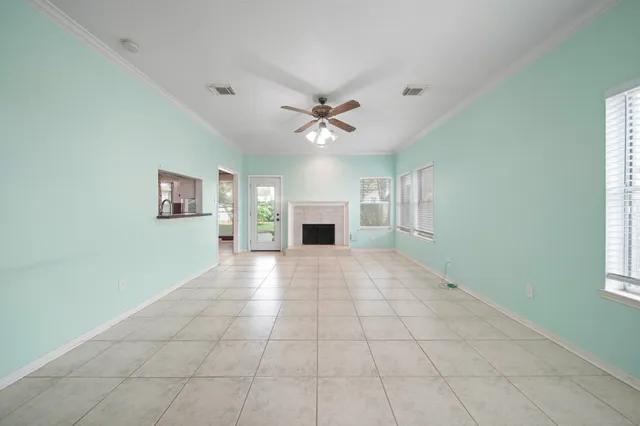 a view of an empty room with a fireplace and a window