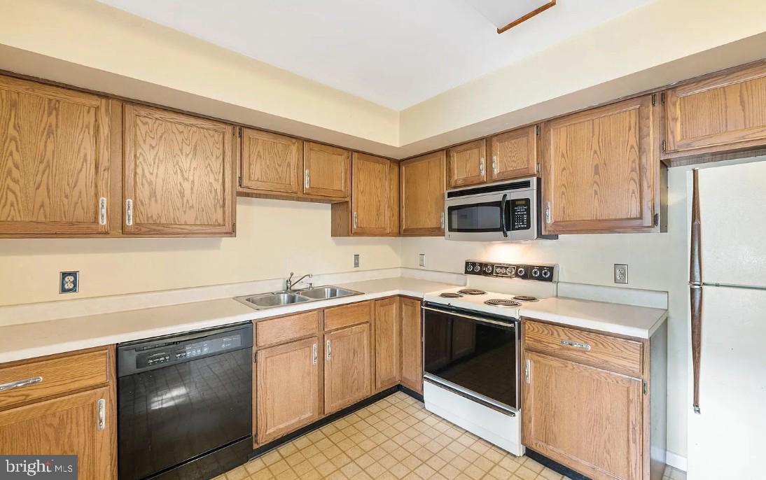 109 Valley Stream Circle, Unit 109A Chesterbrook, PA 19087 - Photo 5 of 8 a kitchen with a sink stove top oven and refrigerator