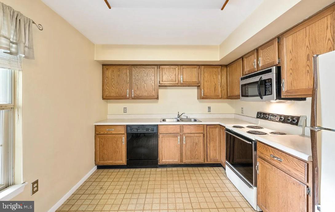 109 Valley Stream Circle, Unit 109A Chesterbrook, PA 19087 - Photo 6 of 8 a kitchen with stainless steel appliances granite countertop a sink stove and refrigerator
