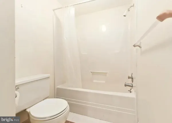 a bathroom with a toilet and a bathtub