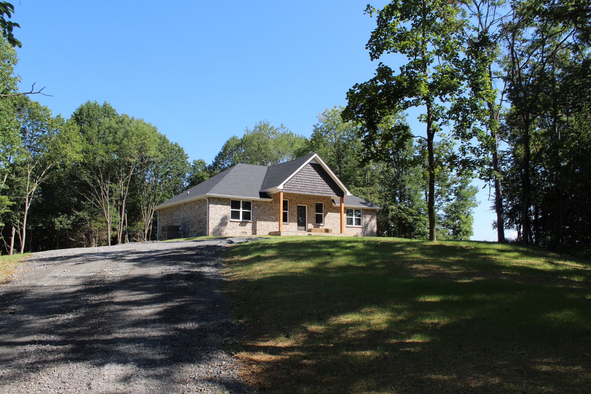 3835 Union Camp Road Lafayette, TN 37083 - Photo 2 of 27 a front view of a house with a garden