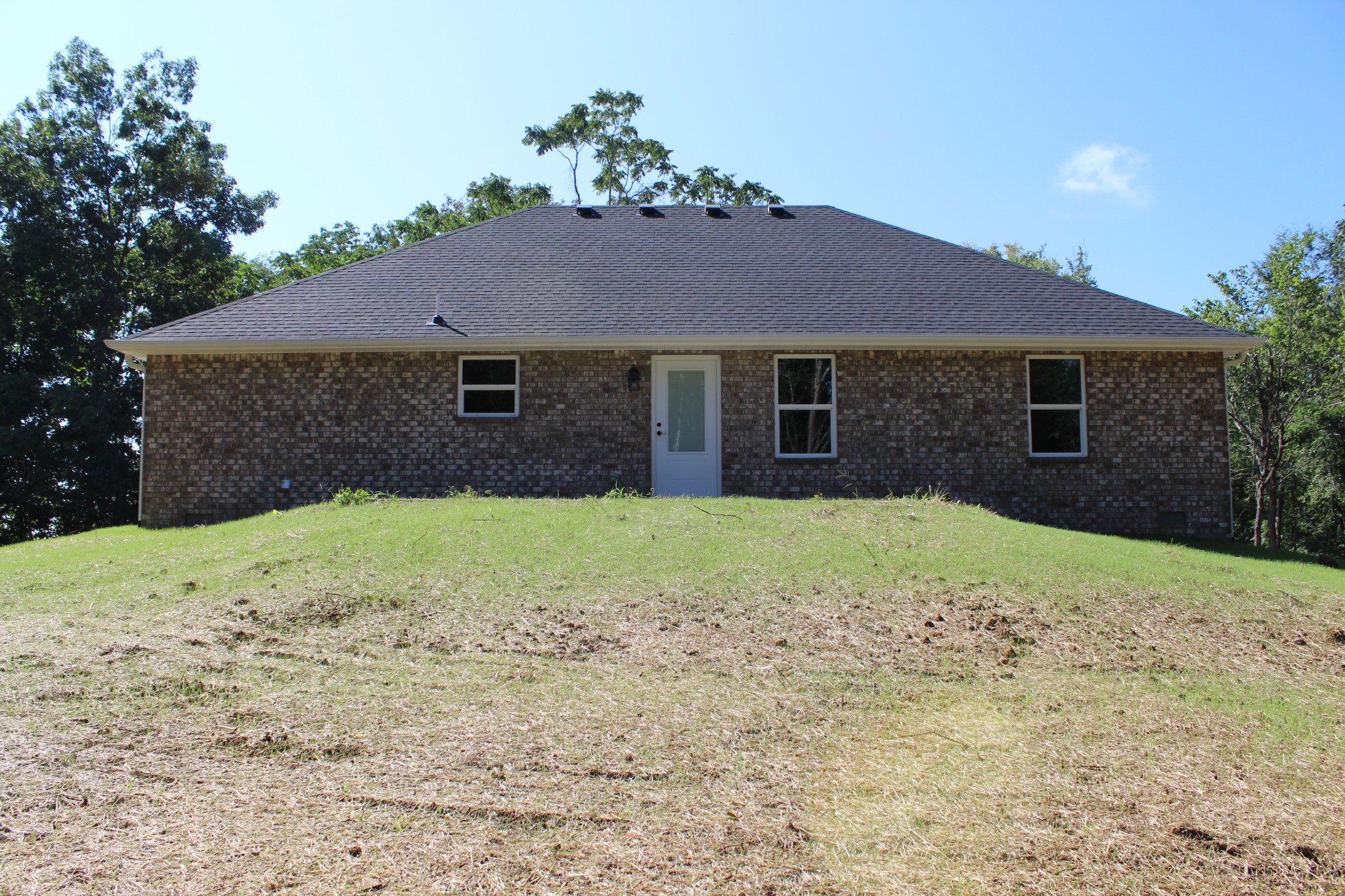 3835 Union Camp Road Lafayette, TN 37083 - Photo 4 of 27 a brick house next to a yard with a large tree