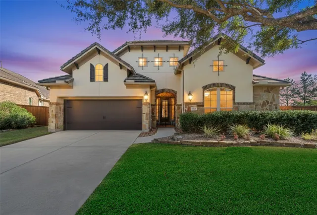 a front view of a house with a yard and garage